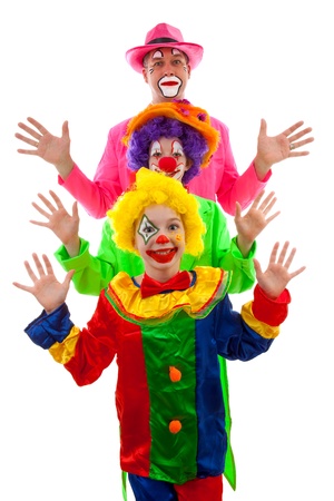 Three people dressed up as colorful funny clowns over white backgroundの写真素材