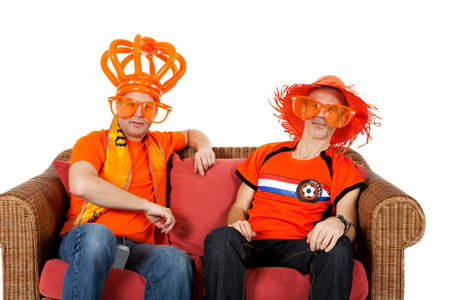 Two Dutch soccer fan watching game over white backgroundの写真素材