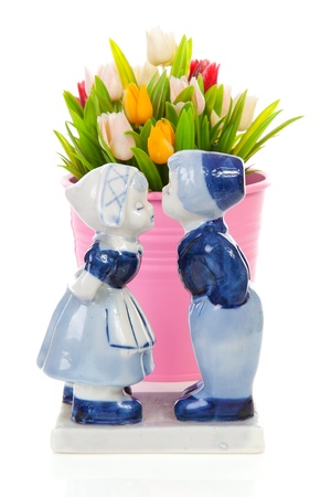 Typical Dutch souvenir in Delft blue and plastic tulips in bucket over white backgroundの写真素材