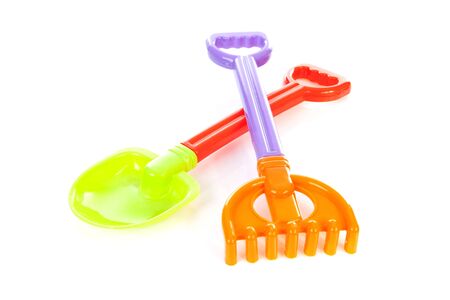 Colorful beach toys; shovel and rake, over white backgroundの写真素材