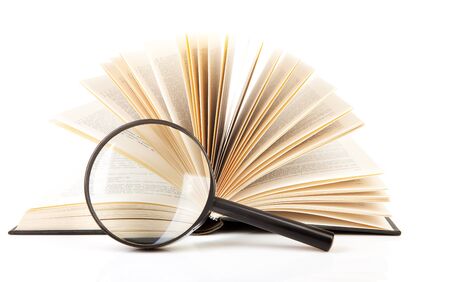 open book with magnifying glass over white backgroundの写真素材