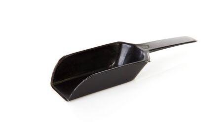 Black plastic measuring spoon over white backgroundの写真素材