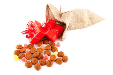 Typical Dutch celebration: Sinterklaas with surprises in bag and ginger nuts, ready for the kids in december. Isolated on white backgroundの写真素材