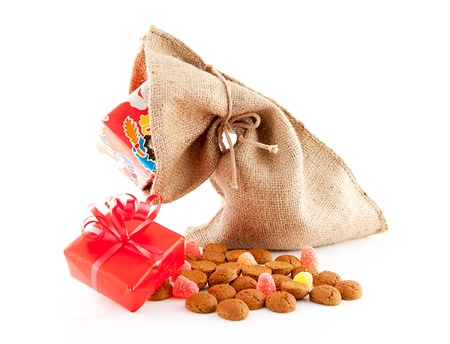 Typical Dutch celebration: Sinterklaas with surprises in bag and ginger nuts, ready for the kids in december. Isolated on white backgroundの写真素材