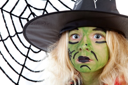 Scary green witch for Halloween with spiderweb over white backgroundの写真素材