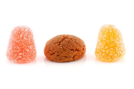 Couple of pepernoten (ginger nuts) and tumtum sweets for typical Dutch festivity at 5 december over white backgroundの写真素材