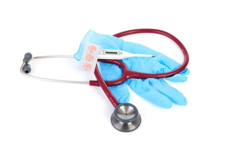 Medical tools with gloves, stethoscope, pills and thermometer over white backgroundの写真素材