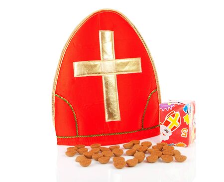 Mitre ( mijter) of Sinterklaas and pepernoten ( ginger nuts), typcal Dutch feast in december over white backgroundの写真素材