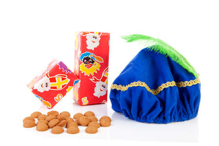 Hat of black pete ( zwarte Piet), gifts and pepernoten ( ginger nuts) for typical Dutch event in decemberの写真素材