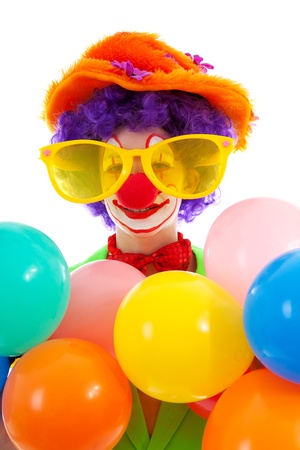 portrait of child dressed as colorful funny clown over white backgroundの写真素材