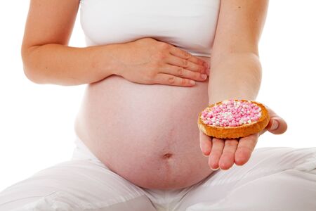 Pregnant belly with pink mice on rusk over white backgroundの写真素材