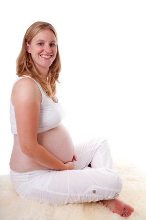 Studio portrait of pregnant woman over white backgroundの写真素材