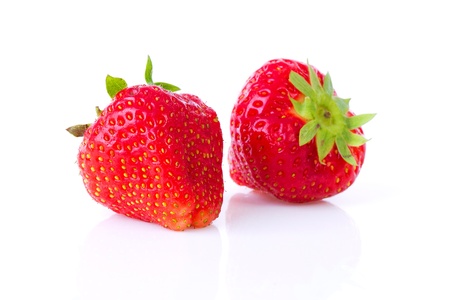 Two strawberries in closeup over white backgroundの写真素材