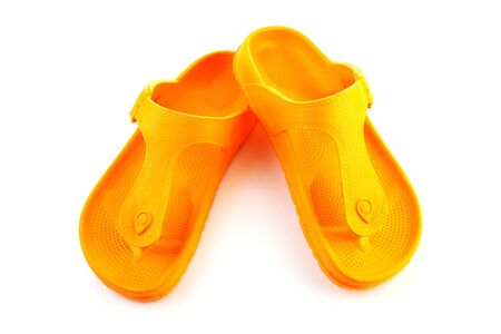orange summer slippers isolated on white backgroundの写真素材