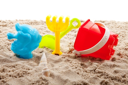colorful plastic toys on the beach over white backgroundの写真素材