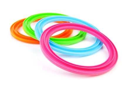Four colorful plastic rings over white backgroundの写真素材
