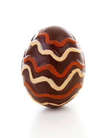 One big brown decorated easter egg over white backgroundの写真素材