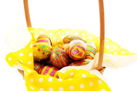basket with easter eggs in closeup over white backgroundの写真素材