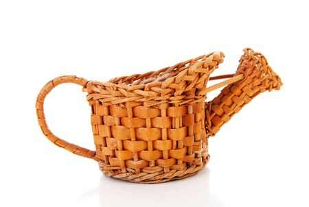 Old cane watering can over white backgroundの写真素材