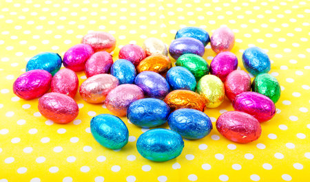 colorful chocolate easter eggs on yellow dotted napkin
