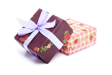 Pile of birthday presents with purple bow isolated on white backgroundの写真素材