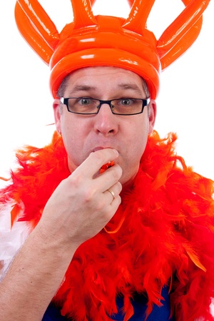 Man is posing in orange outfit for soccer game over white backgroundの写真素材