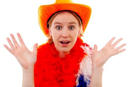 portrait of Dutch soccer fan in orange outfit who looks surprised over white backgroundの写真素材