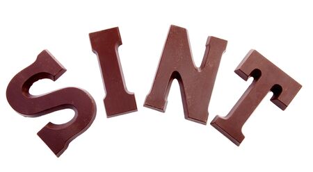 The word "SINT" in chocolate letters isolated on white background, typical Dutch candy for Sinterklaas event in decemberの写真素材