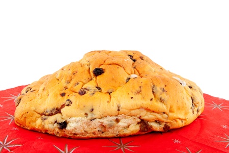 One whole raising bread on christmas napkin over white backgroundの写真素材