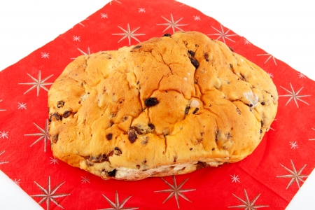 One whole raising bread on christmas napkin over white backgroundの写真素材