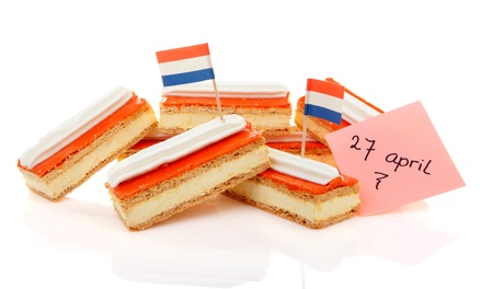 Pile of traditional Dutch pastry called tompouce with flags over white backgroundの写真素材