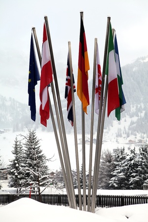 Flags of different nations in the snow of Italyの写真素材