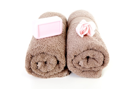 Brown towels and brown soap over white backgroundの写真素材