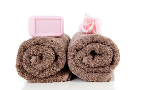 Brown towels and brown soap over white backgroundの写真素材