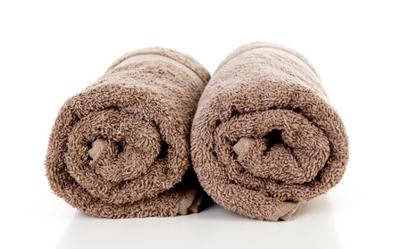 Two rolled brown towels over white backgroundの写真素材