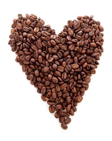 Heart shape made out of coffee beans over white backgroundの写真素材