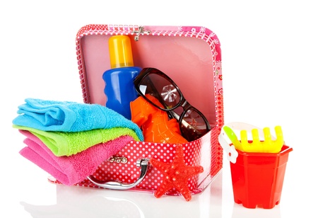 Going to the beach or on vacation; accessories and suitcase over white backgroundの写真素材