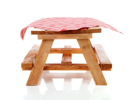 empty picnic table with tablecloth over white backgroundの写真素材
