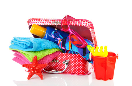 Going to the beach or on vacation; accessories and suitcase over white backgroundの写真素材