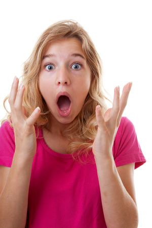 Portrait of girl who looks surprised over white backgroundの写真素材