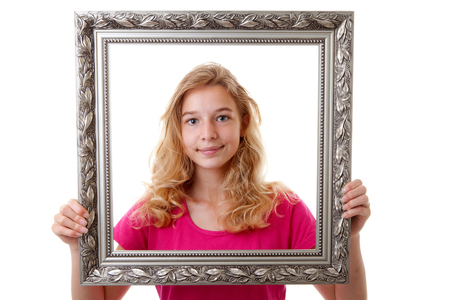 Girl is holding decorated frame over white backgroundの写真素材