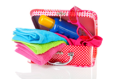 Going to the beach or on vacation; accessories and suitcase over white backgroundの写真素材