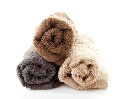 Pile of rolled towels over white backgroundの写真素材