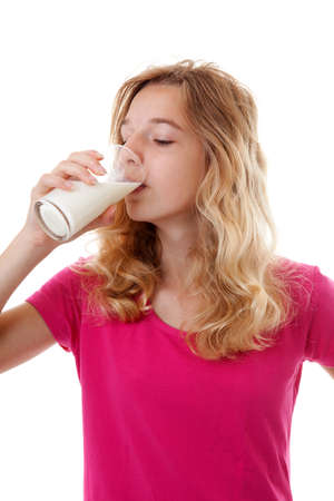 Girl is drinking healthy milk over white backgroundの写真素材