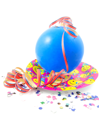 Colorful party accessory with blue balloon and streamers over white backgroundの写真素材