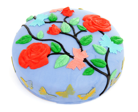 Pie decorated with flowers and butterfly over white backgroundの写真素材