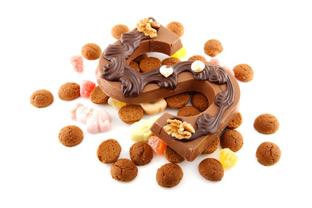 Decorated Chocolate letter S for Sinterklaas with ginger nuts, typical Dutch party in december, isolated on white backgroundの写真素材