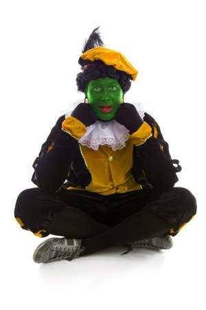 Annoyed Zwarte piet ( black pete) typical Dutch character part of a traditional event celebrating the birthday of Sinterklaas in december over white backgroundの写真素材