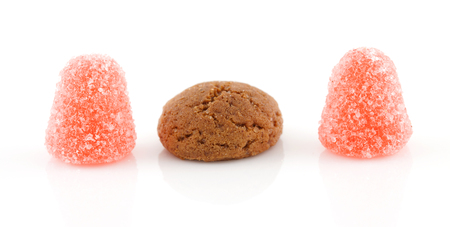 Pepernoot (ginger nuts) and tumtum candy over white backgroundの写真素材