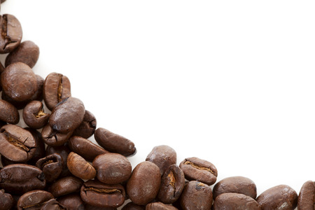 Corner of roasted coffee beans over white backgroundの写真素材